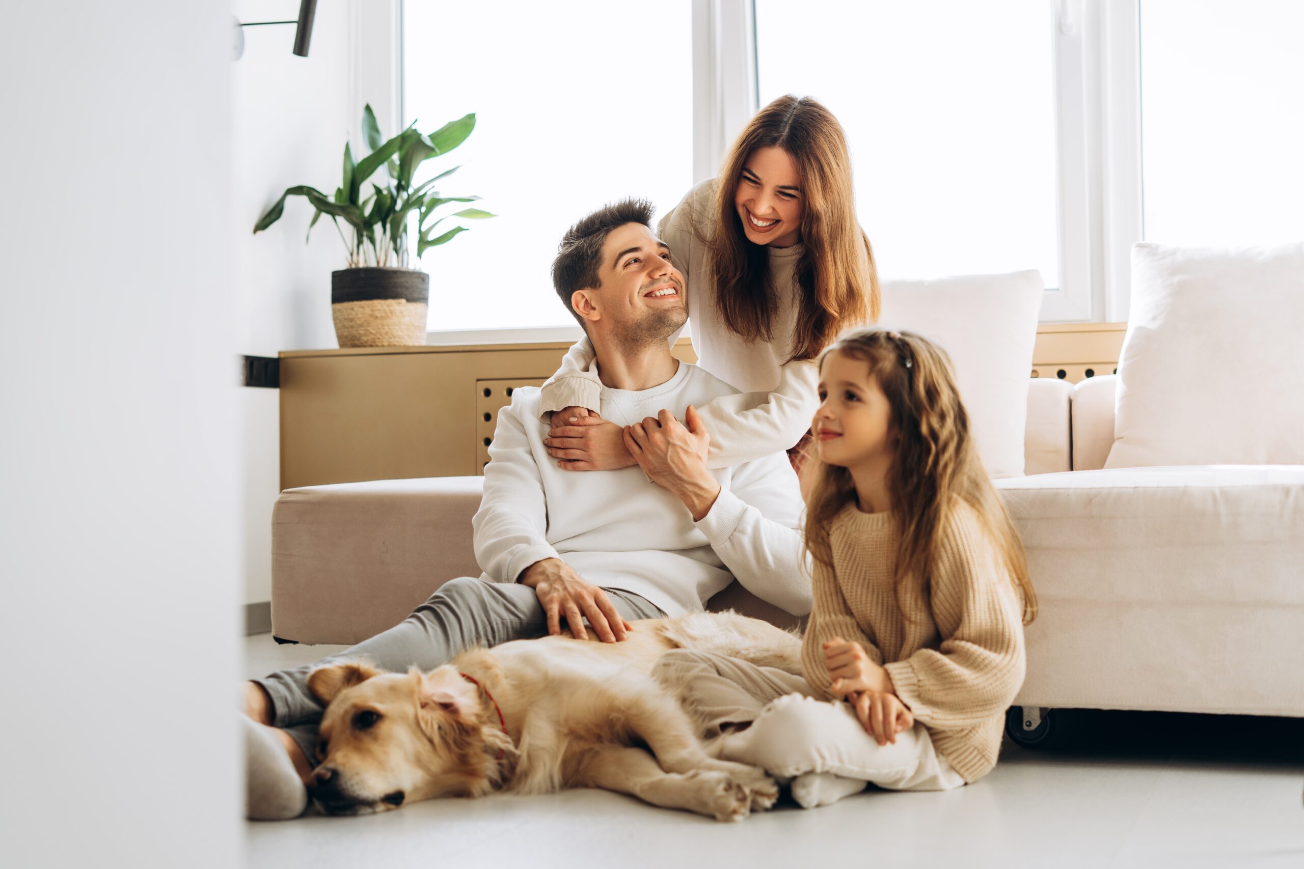 Smiling,Family,Spending,Quality,Time,Together,With,Their,Golden,Retriever